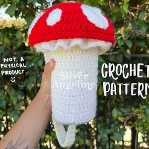 May include: Crochet pattern for a red and white mushroom with a white stem. The pattern is not a physical product. "CROCHET PATTERN!" is written in white text on a black background.