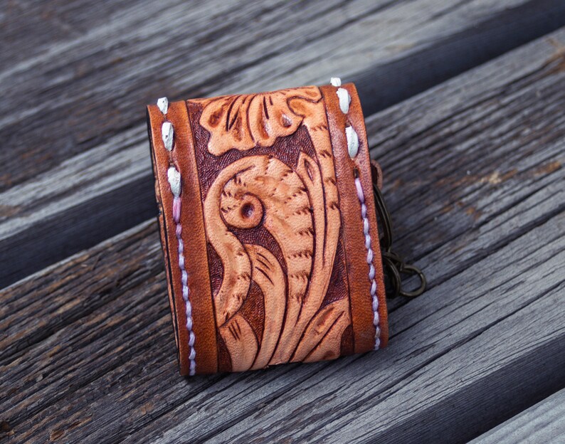 Brown leather keychain with western floral design, personalized tooled leather AirPods case, buck stitching AirPods case