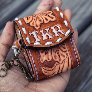 Brown leather keychain with western floral design, personalized tooled leather AirPods case, buck stitching AirPods case