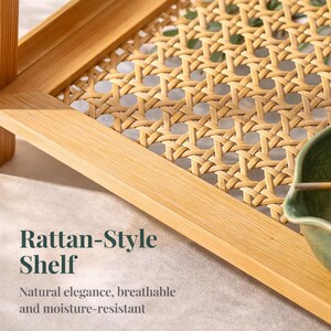 May include: A light brown rattan-style shelf with a woven design. The shelf has a rectangular frame and a woven centre. The text "Rattan-Style Shelf" is displayed on the image, along with the words "Natural elegance, breathable and moisture-resistant."