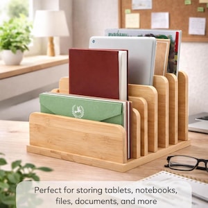 May include: A natural bamboo desk organizer with multiple slots, holding a tablet, notebooks, and files. The organizer has a tiered design and is ideal for keeping a desk tidy. The text at the bottom says "Perfect for storing tablets, notebooks, files, documents, and more."
