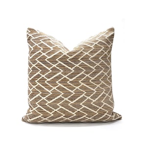 May include: A brown and cream throw pillow with a geometric diamond pattern.
