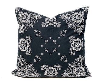 May include: Black and white patterned throw pillow with a paisley design. The pillow is made of a soft, comfortable fabric and is perfect for adding a touch of style to any room.
