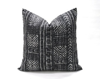 May include: Black and white geometric patterned throw pillow. The pillow has a dark charcoal background with a white geometric pattern.