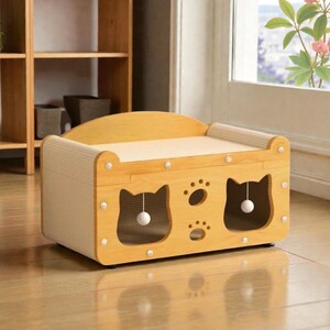 May include: A light wood cat bed with a scratching surface and two cat-shaped openings. The bed has a curved top and a neutral-colored interior. A small white ball hangs inside each cat opening. The bed is decorated with paw prints.