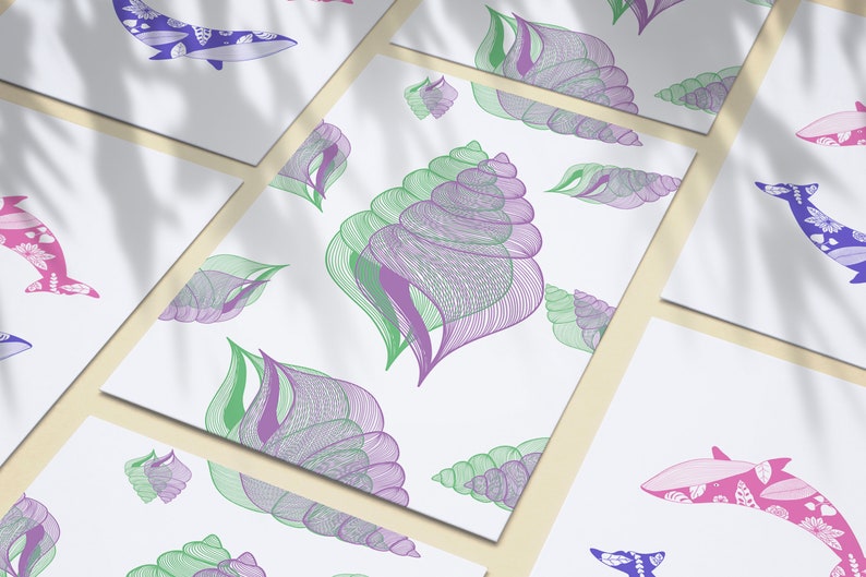 May include: Five white cards with different designs. One card has a purple and green seashell pattern, one card has a pink and purple dolphin, one card has a blue and purple dolphin, one card has a pink and purple dolphin, and one card has a blue and purple dolphin.
