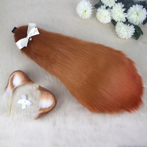 May include: A brown faux fur tail with a white bow and a small bell. The tail is attached to a headband with two white faux fur ears.