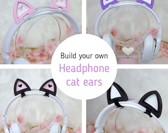 May include: Four pairs of cat ear headphones in different colors: pink, purple, black, and white. The headphones are white with a black headband. The cat ears are made of soft foam and are attached to the headband with a clip. The text "Build your own headphone cat ears" is in the center of the image.