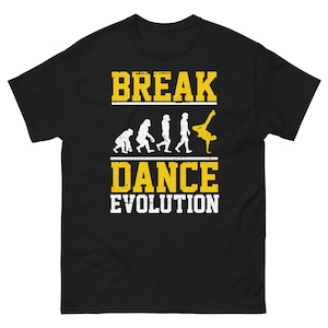 May include: Black t-shirt with a yellow graphic of a breakdancing evolution. The graphic shows a series of stick figures in different breakdancing poses, starting with a simple standing figure and ending with a figure in a complex breakdancing move. The text "Break Dance Evolution" is written in yellow letters below the graphic.