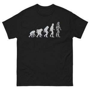 May include: A black t-shirt with a white graphic of the evolution of humans ending with a robot.