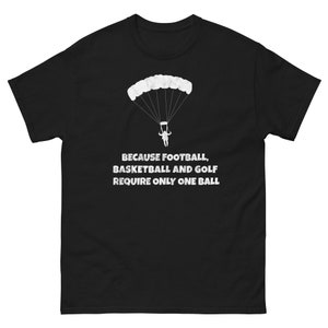 May include: Black t-shirt featuring a white silhouette of a skydiver with a parachute and the text "Because football, basketball and golf require only one ball."