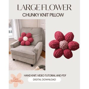 May include: A large, chunky knit flower pillow in shades of red and white. The pillow is shaped like a flower and is displayed on a gray armchair. The text "LARGE FLOWER CHUNKY KNIT PILLOW" is at the top of the image.