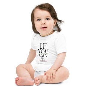 May include: White baby onesie with the text "IF YOU CAN READ THIS YOU SHOULD GET YOUR EYES CHECKED" in black letters.
