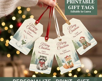 May include: A hand holds several Christmas gift tags with red, white, and gold ribbons. Each tag features a winter scene with a different animal and the text "Merry Christmas" and "Love The Johnsons". The tags also say "Printable Gift Tags" and "Personalize Print Gift".