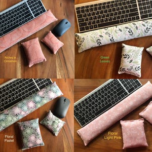 May include: Four sets of keyboard wrist rests and matching small pillows in various patterns and colors. The sets include a keyboard, a wrist rest, a mouse, and two small pillows. The patterns include arches in cinnamon, green leaves, floral pastel, and floral light pink.