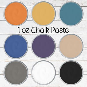 May include: Nine small, round containers of chalk paste in various colors, including orange, yellow, teal, blue, purple, beige, gray, white, and black. The text "1 oz Chalk Paste" is printed in black.