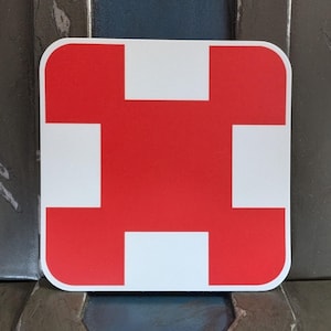 May include: A red square with four white squares inside, forming a cross shape.