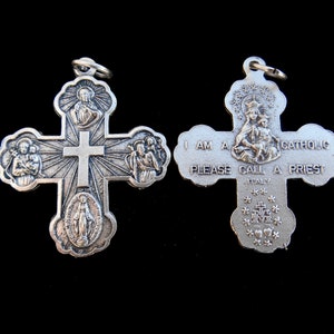 May include: Silver metal cross pendant with religious imagery. The front features a central cross with four smaller images of saints. The back features the text "I am a Catholic. Please call a priest. Italy."