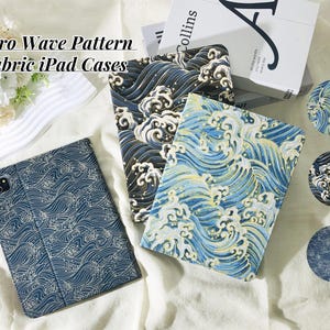May include: Retro Wave Pattern Fabric iPad Cases with a blue and white wave design. The cases are made of fabric and have a retro wave pattern. The cases are shown on a white surface.