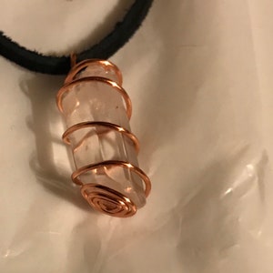 Hand twisted copper spiral cage With quartz crystal stone.
