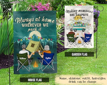 May include: Two personalized garden flags with a camping theme. The house flag features a couple sitting by a campfire in front of a tent with the text "Always at home WHEREVER WE park it". The garden flag features a couple sitting by a campfire with a camper van in the background and the text "Making memories ONE CAMPSITE at a time".