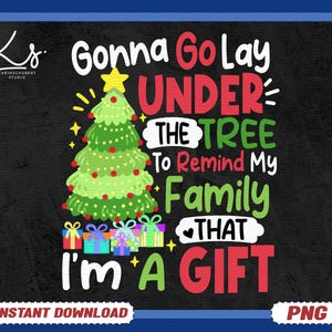 May include: A black background with a Christmas-themed graphic. The text reads "Gonna Go Lay UNDER THE TREE To Remind My Family THAT I'M A GIFT." A green Christmas tree with red ornaments and a yellow star is in the center.