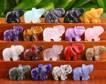 May include: A collection of 18 small elephant figurines carved from various types of gemstones, including amethyst, rose quartz, tiger's eye, and lapis lazuli.