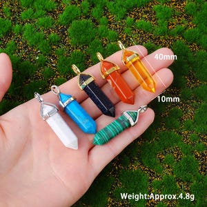 Natural double terminated crystal pendant featuring a hexagonal prism gemstone point with polished finish and metal cap. making it lightweight and comfortable for everyday wear. Available in multiple gemstone styles and colors. The top metal bail in gold or silver tone allows easy attachment to chains, cords, or jewelry findings. This double point crystal pendant is ideal for necklace making, DIY jewelry design, chakra jewelry, energy crystal accessories, and handmade craft projects.