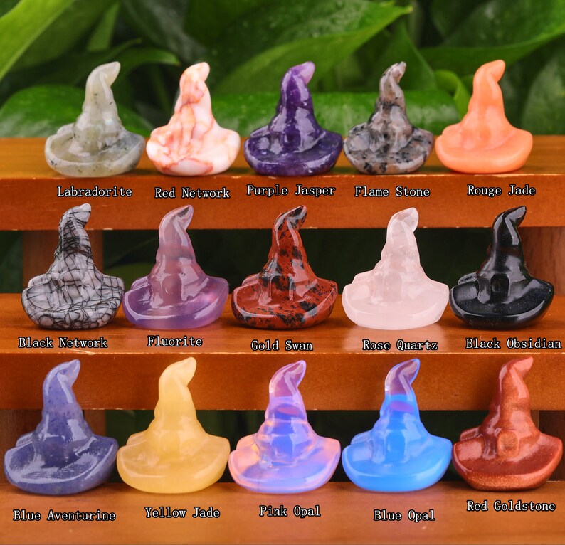 May include: A collection of 15 witch hat shaped crystal carvings in various colours and stone types, including labradorite, red network, purple jasper, flame stone, rouge jade, black network, fluorite, gold swan, rose quartz, black obsidian, blue aventurine, yellow jade, pink opal, blue opal, and red goldstone.