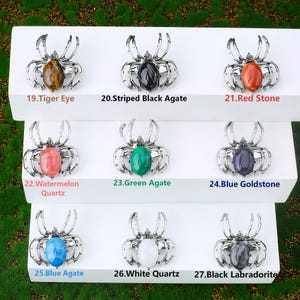 Handcrafted natural crystal spider featuring a polished gemstone body set in a finely crafted alloy spider frame. designed with natural stones creating a luxurious and artistic jewelry piece. The smooth gemstone surface and detailed spider legs give it a striking and elegant appearance. Perfect as a pendant necklace or brooch accessory symbolizing creativity, protection, and good fortune. Ideal for meditation energy healing, spiritual balance, fashion styling, gift giving, and decorative display