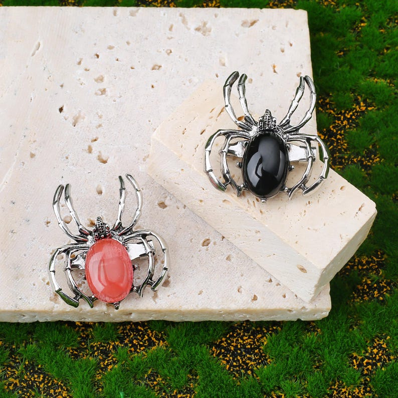 Handcrafted natural crystal spider featuring a polished gemstone body set in a finely crafted alloy spider frame. designed with natural stones creating a luxurious and artistic jewelry piece. The smooth gemstone surface and detailed spider legs give it a striking and elegant appearance. Perfect as a pendant necklace or brooch accessory symbolizing creativity, protection, and good fortune. Ideal for meditation energy healing, spiritual balance, fashion styling, gift giving, and decorative display