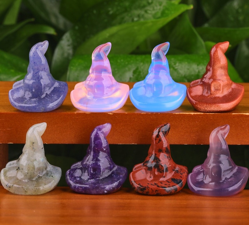 May include: Set of ten crystal witch hats in various colours, including amethyst, clear, red, and green. The hats are carved from natural stones and are approximately 5 cm tall.