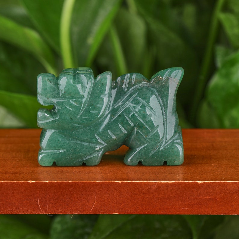 May include: A green jade carving of a dragon, a mythical creature often associated with good luck and prosperity in Chinese culture.