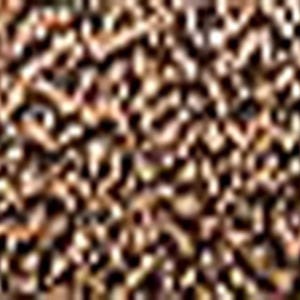 May include: Close-up of a textured surface with a pattern of small, irregular shapes in shades of brown and tan. The surface appears to be made of a natural material, possibly wood or stone, with a rough, uneven texture.