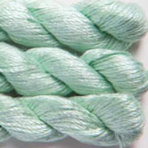 May include: Close-up of several skeins of light green yarn. The yarn is tightly twisted, showing a textured surface. The color is a soft, pastel green, suitable for various crafting projects.