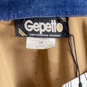 May include: A brown and tan shirt with a denim collar. The shirt has a label that reads "Gepetto Copyrighted Designs 100% Polyester Assembled in Mexico of U.S.A. Components Large".