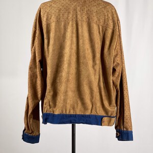 May include: A brown suede jacket with a denim collar and cuffs. The jacket has a dotted pattern on the sleeves and back.