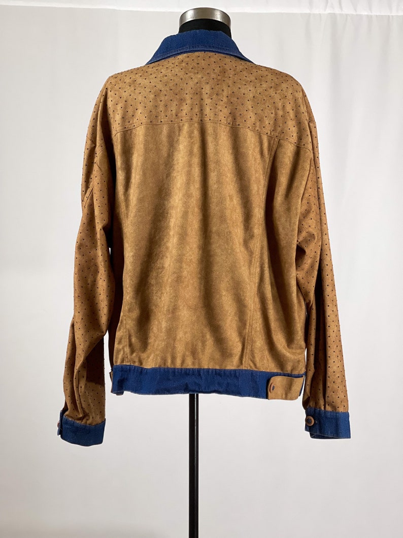 May include: A brown suede jacket with a denim collar and cuffs. The jacket has a dotted pattern on the sleeves and back.