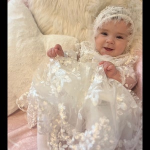 Beautiful, long off white christening dress made of beautiful tulle, embroidered with flowers, with long sleeves.