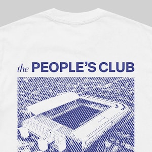 May include: White t-shirt featuring the text "the PEOPLE'S CLUB" in blue above a blue and white graphic of a stadium. The shirt has a crew neck and short sleeves.