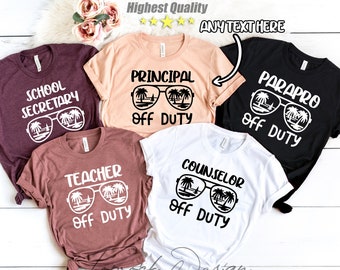 May include: Five t-shirts in various colors, each with a different job title printed in white. The shirts feature a sunglasses graphic with a beach scene and the words "OFF DUTY". Titles include "School Secretary", "Teacher", "Principal", "Parapro", and "Counselor".