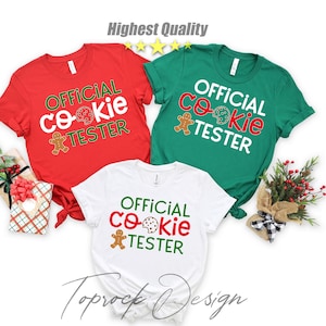 May include: Three Christmas themed t-shirts with the text "Official Cookie Tester" and a gingerbread man graphic. The shirts are red, green, and white.