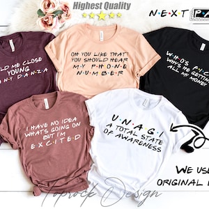 May include: Five different t-shirts with various text and designs inspired by the popular TV show "Friends". The shirts are all white, black, brown, or pink.