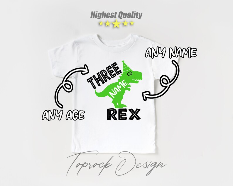 May include: White t-shirt with a green dinosaur wearing a party hat. The dinosaur says "NAME REX" and the text "THREE" is above the dinosaur. The text "ANY NAME" and "ANY AGE" are written on the shirt.