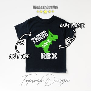 May include: Black t-shirt with a green dinosaur wearing a party hat. The dinosaur says "Three Name Rex" on it. The text "Any Name" is written above the dinosaur and "Any Age" is written below the dinosaur.