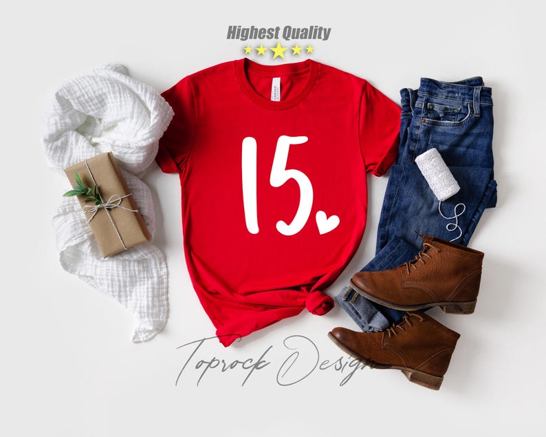 May include: Red t-shirt with the number 15 and a small white heart printed on the front. The shirt is on a white background.