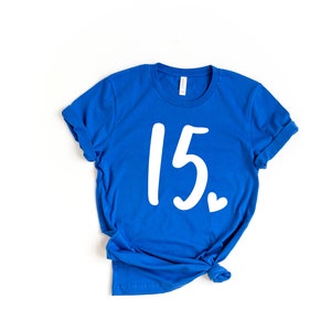 May include: A royal blue t-shirt with the number 15 and a small heart printed in white.