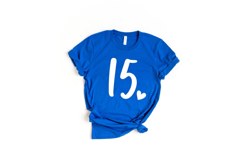 May include: A royal blue t-shirt with the number 15 and a small heart printed in white.