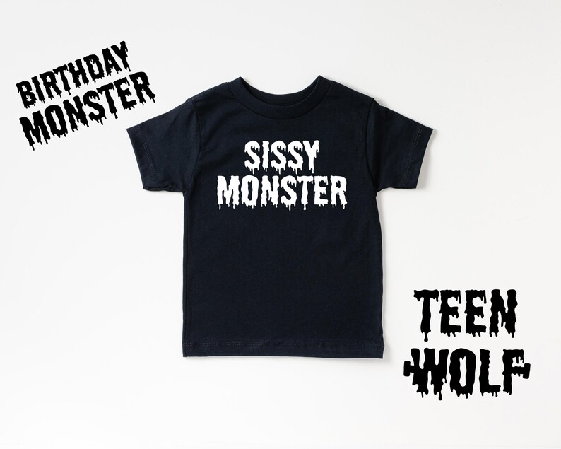 May include: Black t-shirt with white text that reads "Sissy Monster".