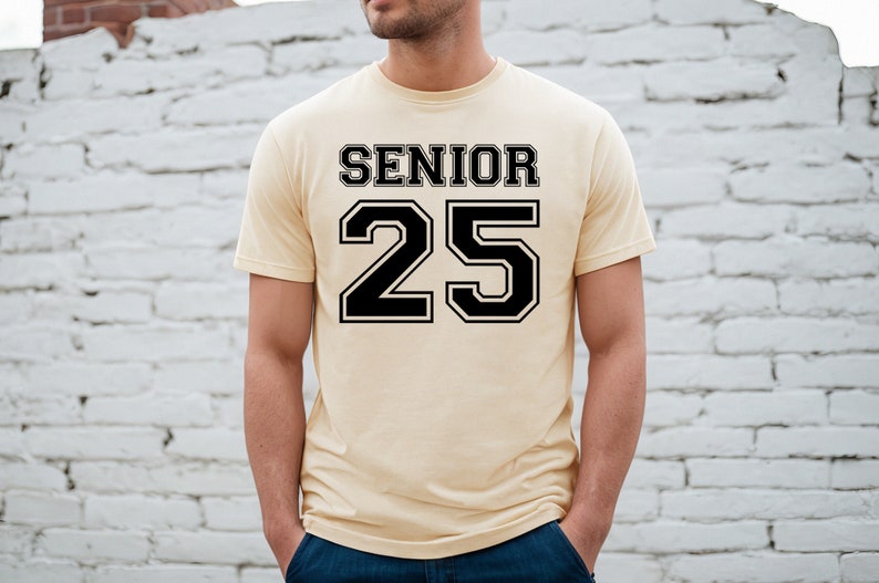 May include: A light yellow t-shirt with black text that says "Senior 25" in a varsity style font.